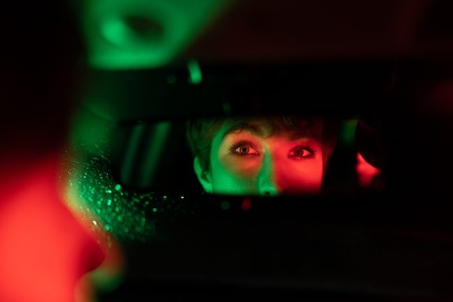 Eyes,Of,European,Woman,Are,Reflected,In,Automotive,Mirror,Riding